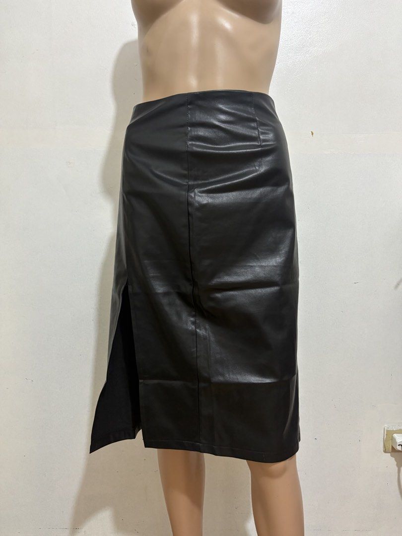 Black Faux Leather Midi Skirt with Side Split (Category: Skirts) located in Cainta. Submitted by tokadore (Listing ID 1468966270, Image 1). Description: - Color: Classic black - Material: Smooth faux leather - Style: High waist midi skirt with back zipper - Detail: Front side slit for easy movement - Condition: Good, but has a small tear at the top corner of the slit seam that needs a quick stitch L- 25 W -30.