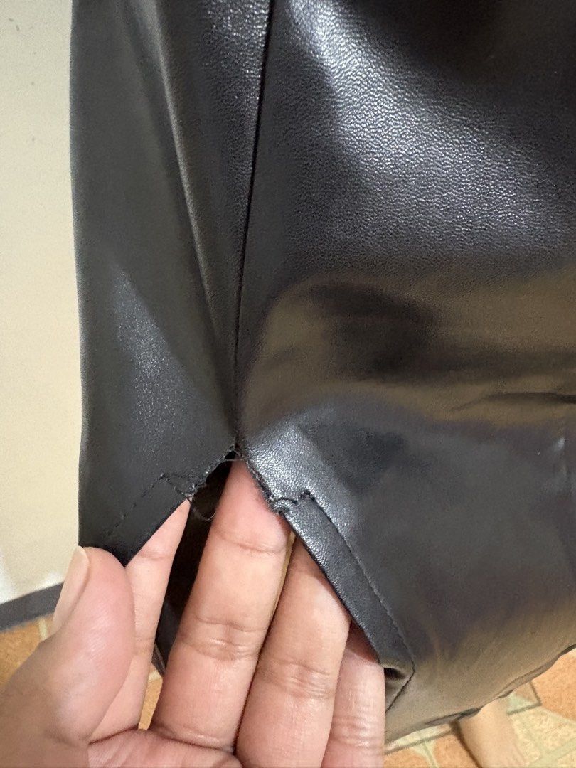 Black Faux Leather Midi Skirt with Side Split (Category: Skirts) located in Cainta. Submitted by tokadore (Listing ID 1468966270, Image 2). Description: - Color: Classic black - Material: Smooth faux leather - Style: High waist midi skirt with back zipper - Detail: Front side slit for easy movement - Condition: Good, but has a small tear at the top corner of the slit seam that needs a quick stitch L- 25 W -30.