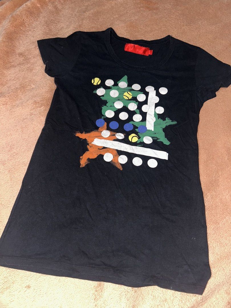 Black Graphic T-Shirt with Abstract Print (Category: Shirts) located in Manila. Submitted by prelovedbyanavi (Listing ID 1468957384, Image 1). Description: - Color: Black - Design: Colorful abstract geometric print and dot pattern (green, orange, blue, white) - Fit: Regular fit, short sleeves - Material: Comfortable cotton - Details: Crew neckline with red interior tag, solid black back - Condition: Lightly used - Style: Casual everyday wear.