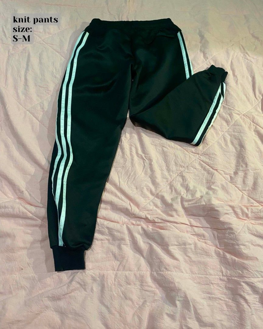 Black knit pants with white side stripes (Category: Jeans) located in Santa Cruz. Submitted by gelpcz (Listing ID 1468951781, Image 1). Description: - Color: Black with classic white stripes down the sides - Material: Soft knit fabric, highly comfortable - Features: Elastic waistband and ribbed ankle cuffs - Best for: Daily wear or lounging at home - Size: Fits S-M comfortably.