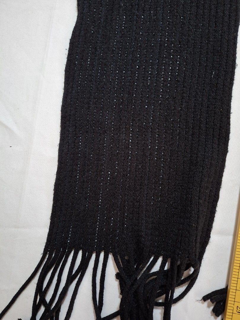 Black Knitted Scarf with Fringe (Category: Scarves) located in Baguio. Submitted by restyrille77846 (Listing ID 1469053691, Image 2). Description: - Color: Classic Black - Material: Knitted fabric with a stylish ribbed texture - Details: Finished with fringe ends on both sides - Dimensions: Approx. 29" length x 8" width - Condition: Clean, fresh, and ready to wear - Style Tip: Versatile everyday accessory that pairs easily with coats and jackets 