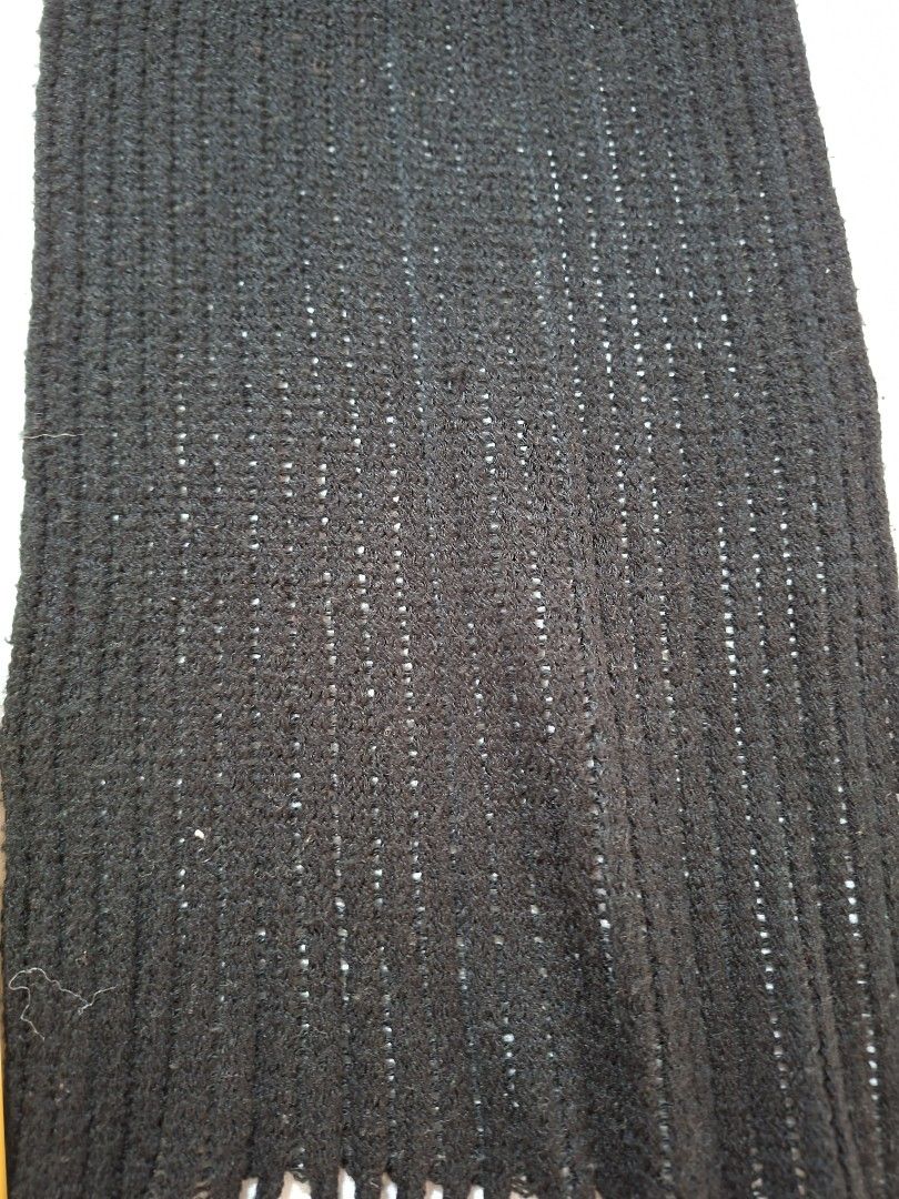 Black Knitted Scarf with Fringe (Category: Scarves) located in Baguio. Submitted by restyrille77846 (Listing ID 1469053691, Image 3). Description: - Color: Classic Black - Material: Knitted fabric with a stylish ribbed texture - Details: Finished with fringe ends on both sides - Dimensions: Approx. 29" length x 8" width - Condition: Clean, fresh, and ready to wear - Style Tip: Versatile everyday accessory that pairs easily with coats and jackets 