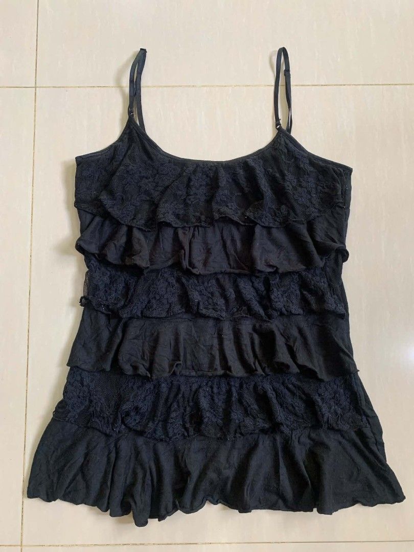 Black Layered Ruffle Lace Cami Tank Top (Category: Sleeveless) located in Tiaong. Submitted by cdoswan (Listing ID 1469120107, Image 1). Description: -xs to small - Color: Classic black - Design: Alternating rows of solid fabric and lace ruffles - Straps: Adjustable thin shoulder straps - Neckline: Flattering scoop neckline - Styling: Great for layering or standalone wear.