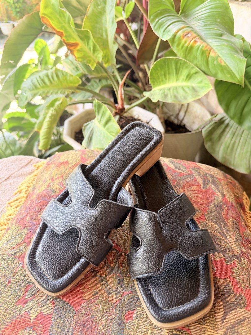Black Leather H-Band Square Toe Sandals (Category: Flats & Sandals) located in Manila. Submitted by sedpuprincess (Listing ID 1469008382, Image 1). Description: - Material: Premium black textured leather - Design: Iconic H-cutout strap with a modern square toe - Comfort: Padded insole and easy slip-on style for all-day wear - Heel: Flat design with a stylish wooden grain finish - Versatility: Perfect match for casual dresses, shorts, or denim jea