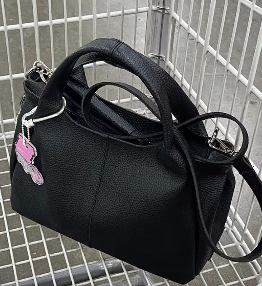black mini leather bag with sling (Category: Tote Bags) located in Quezon City. Submitted by kalmai (Listing ID 1469026212, Image 2). Description: height 5.5" length 9"-12" width 3" - Material: Premium black pebble leather with sleek silver hardware - Versatility: Includes dual top handles and a detachable and adjustable sling - Design: Structured, compact shape perfect for everyday use - Extras: Features an adorable detachable pink key charm - C