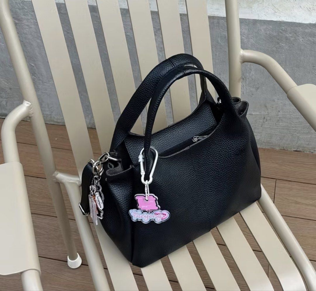 black mini leather bag with sling (Category: Tote Bags) located in Quezon City. Submitted by kalmai (Listing ID 1469026212, Image 1). Description: height 5.5" length 9"-12" width 3" - Material: Premium black pebble leather with sleek silver hardware - Versatility: Includes dual top handles and a detachable and adjustable sling - Design: Structured, compact shape perfect for everyday use - Extras: Features an adorable detachable pink key charm - C