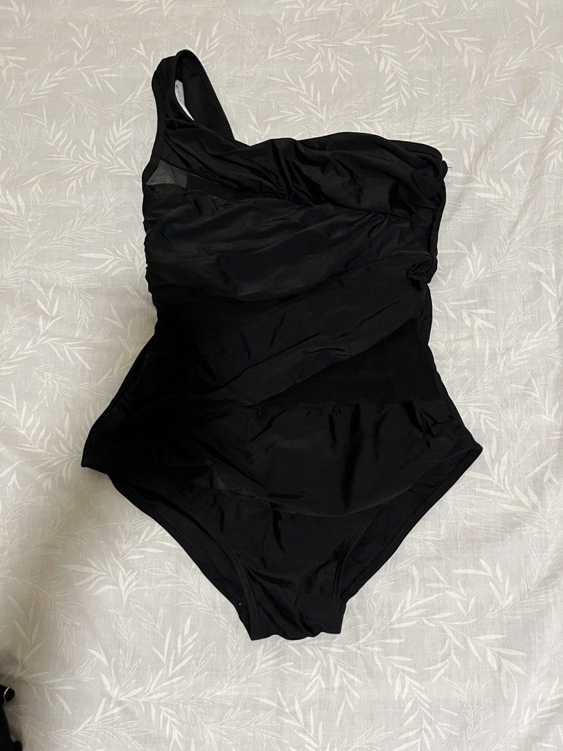 Black One-Shoulder Mesh Ruffle One-Piece Swimsuit (Category: Bikinis & Swimsuits) located in Taytay. Submitted by prelovedbyblaire (Listing ID 1469100007, Image 1). Description: - Color: Black - Design: One-shoulder strap with stylish ruched front - Detail: Sheer mesh panel insert near the chest area - Cut: Classic bottom cut - Material: Smooth and stretchy for a comfortable fit - Condition: Brand new / Excellent quality.