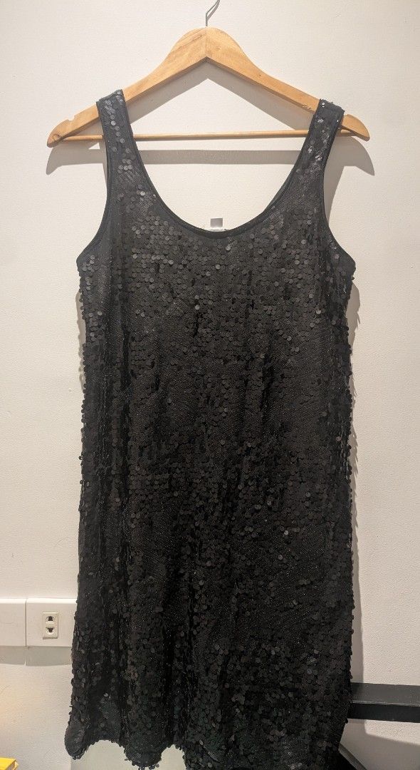 Black sequin sleeveless dress (Category: Dresses) located in Quezon City. Submitted by moonjay2026 (Listing ID 1469022783, Image 1). Description: - Size: Can fit Large - Style: Party, night out, or special events - Design: Fully covered in sequins (front and back) with a scoop neckline - Fit: Standard fit, sleeveless mini length - Versatility: Easy to pair with heels or boots - Condition: Brand new and ready to wear - Never been used. Natago lang
