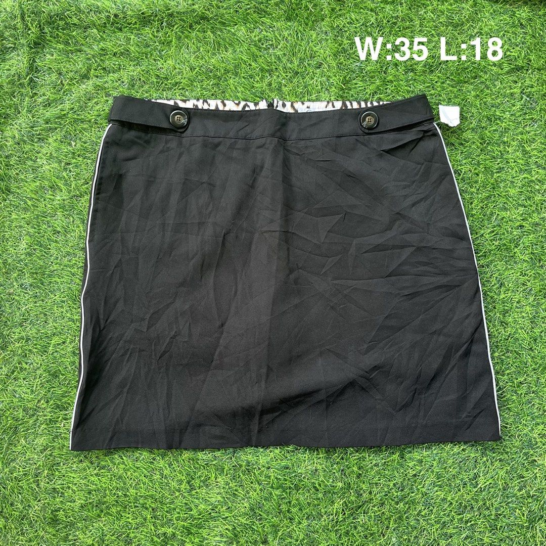 Black Skort with Built-in Shorts Size 10 (Category: Skirts) located in Cuyapo. Submitted by Ashtyn.Pre.Loved (Listing ID 1469069916, Image 1). Description: - Style: Athletic skort with built-in shorts underneath - Size: 10 - Measurements: Waist 35", Length 18" - Material: Comfortable polyester and spandex blend - Design: Classic black with stylish white piping on the sides - Details: Chic leopard print lining on the inner waistband, front button 