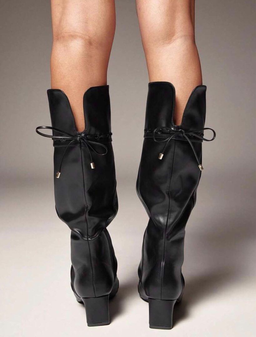 Black slouched knee-high boots with bow tie back (Category: Boots) located in Manila. Submitted by jiro066865 (Listing ID 1468949368, Image 2). Description: - Style: Slouchy knee-high boots with a chic pointed toe and pull-on design - Heel: Comfortable chunky block heel for everyday height - Details: Split back collar with thin string ribbon and metallic aglets, plus stylish stitching on toe cap and upper collar - Versatility: Great pair for skir