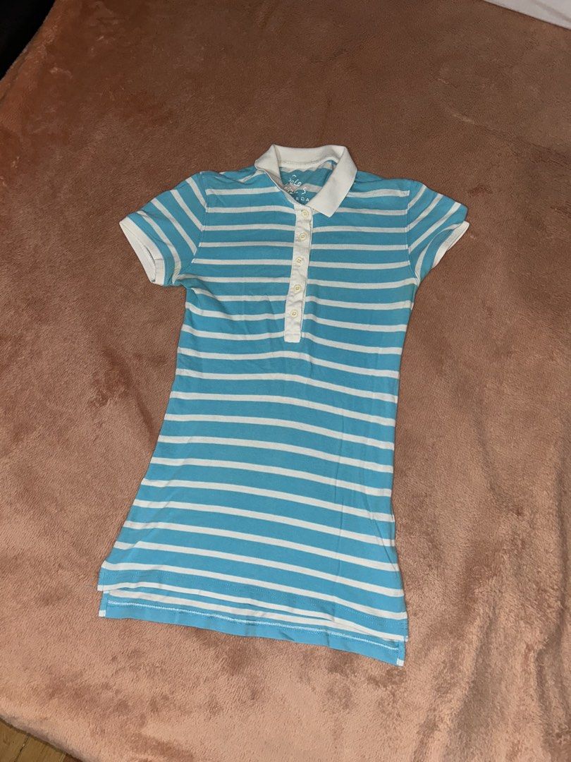 Blue and White Striped Polo Shirt (Category: Others Tops) located in Manila. Submitted by prelovedbyanavi (Listing ID 1468954727, Image 1). Description: - Design: Blue and white striped slim-fit polo - Features: Short sleeves, classic collar neckline, front button placket - Material: Soft and comfortable fabric with bright colors - Style: Great casual piece for everyday wear.