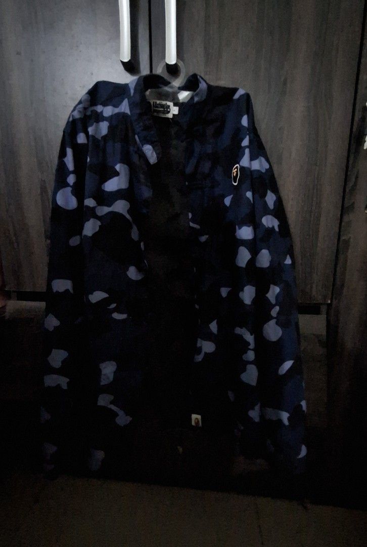 Blue camo kimono style jacket (Category: Coats, Jackets and Outerwear) located in Manila. Submitted by matter514 (Listing ID 1469117707, Image 1). Description: Colorway: Dark blue and black camouflage - Closure: Button-up front - Details: Iconic ape head logo patch on chest, clear inner brand tag - Style: Perfect layering piece for streetwear outfits.