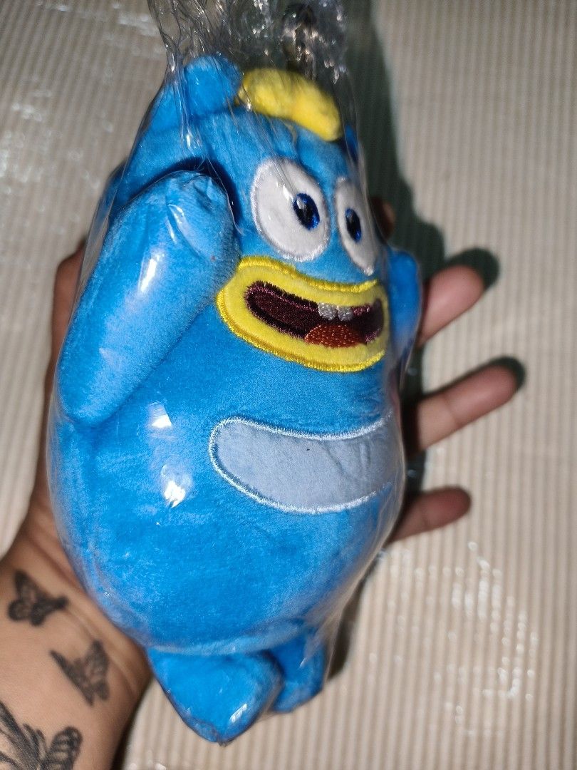 Blue cartoon monster plush keychain (Category: Plushies & Soft Toys) located in Manila. Submitted by reascheyss51406 (Listing ID 1468942992, Image 3). Description: - Adorable blue monster plush toy - Features big googly eyes, a yellow-bordered mouth, and two cute teeth - Soft fabric body with a round tummy patch - Equipped with a sturdy key ring at the top - Brand new and sealed tight in original clear plastic wrapping - Ideal as a cute accessory