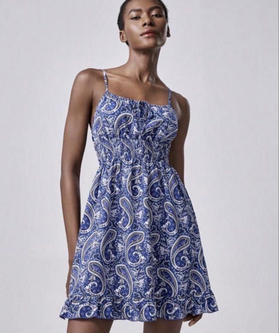 Blue Paisley Print Spaghetti Strap Mini Dress (Category: Dresses) located in Roxas City. Submitted by sherien22 (Listing ID 1469065969, Image 1). Description: - Style: Blue and white paisley print mini dress - Straps: Thin adjustable spaghetti straps with a cute tie detail at the bust - Fit: Comfortable smocked elastic bodice for a flexible, flattering fit - Details: Trendy ruffle hem at the bottom - Fabric: Lightweight and breathable, perfect fo