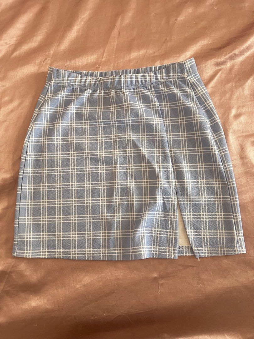 Blue Plaid Mini Skirt with Front Slit (Category: Skirts) located in Manila. Submitted by lovedbymidge (Listing ID 1468996078, Image 1). Description: 🩷 for xs-s girlies (worn once) 🚚 lalamove or grab express (sf shouldered by the buyer) - Trendy blue and white plaid mini skirt - Comfy elastic waistband for an easy slip-on fit - Cute small side slit near the hem - Soft and stretchy fabric - Perfect for casual everyday wear.