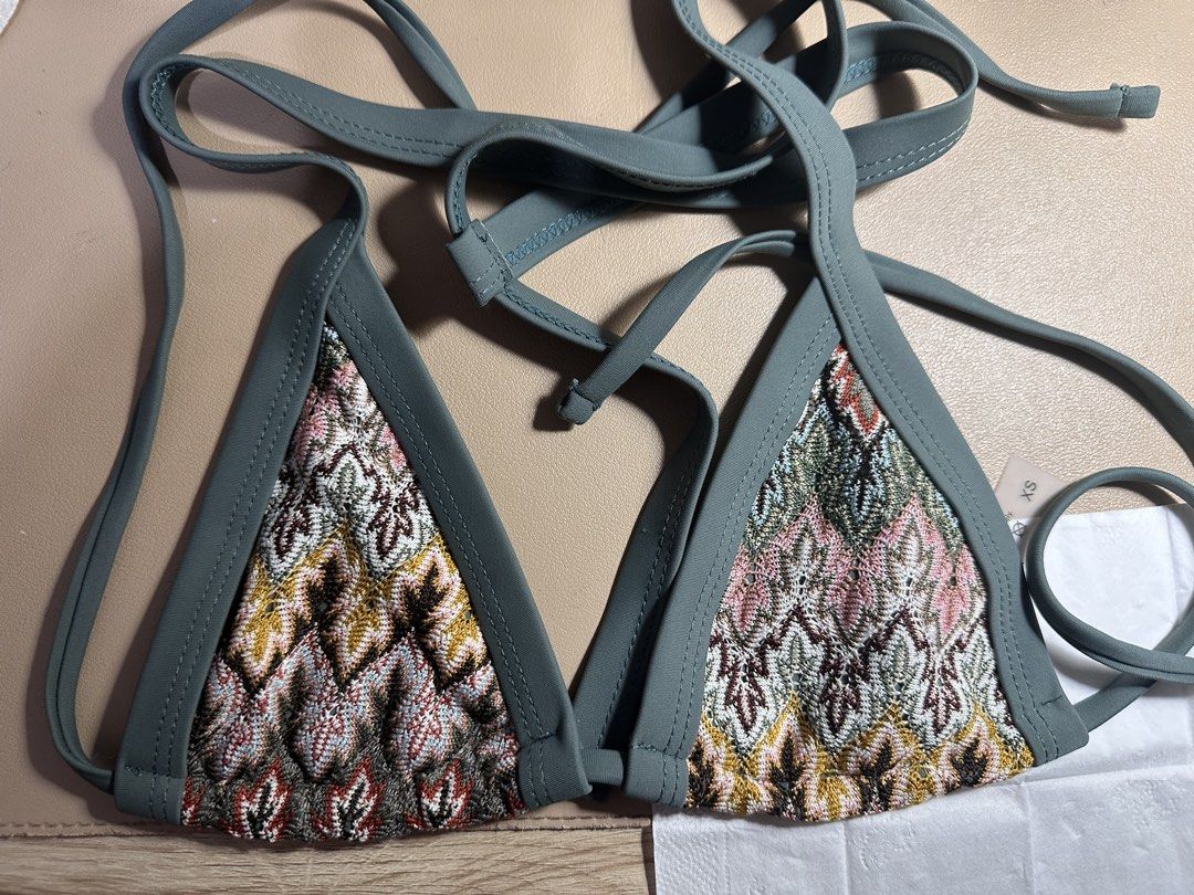Bohemian bikini set (Category: Bikinis & Swimsuits) located in Pasig City. Submitted by prelovedbysco (Listing ID 1469036424, Image 2). Description: - Style: Knit triangle bikini set with chic multicolored geometric pattern and sage green trim - Fit: Super flattering with adjustable halter neck, back ties, and V-shape cheeky bottoms - Size: XS (tag attached) - Condition: Worn once for a quick beach trip, freshly washed and clean - Perfect for you
