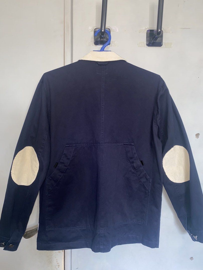 Botanist Navy Chore Jacket (Category: Coats, Jackets and Outerwear) located in Manila. Submitted by antonvarga38504 (Listing ID 1468983473, Image 2). Description: - Brand: Botanist - Color: Navy Blue - Size: Medium - Design details: Contrasting white corduroy collar and round elbow patches on both sleeves - Closure: Button-up front with metallic buttons - Pockets & Features: Multiple utility pockets on the chest and lower front, plus a functional