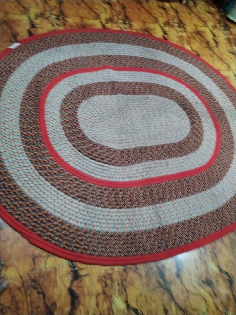 Braided Oval Rug Red Brown Multi 87x73 Inches (Category: Carpets, Mats & Flooring) located in Caloocan City. Submitted by rowely_jpn (Listing ID 1469100659, Image 2). Description: Japan surplus - Product: Oval braided rug with concentric rings - Size: 87 x 73 inches (based on handwritten label) - Color & Pattern: Red, brown, and multicoloured patterned weave - Material: Textured cotton/fabric construction - Durability: Heavy-duty floor covering -