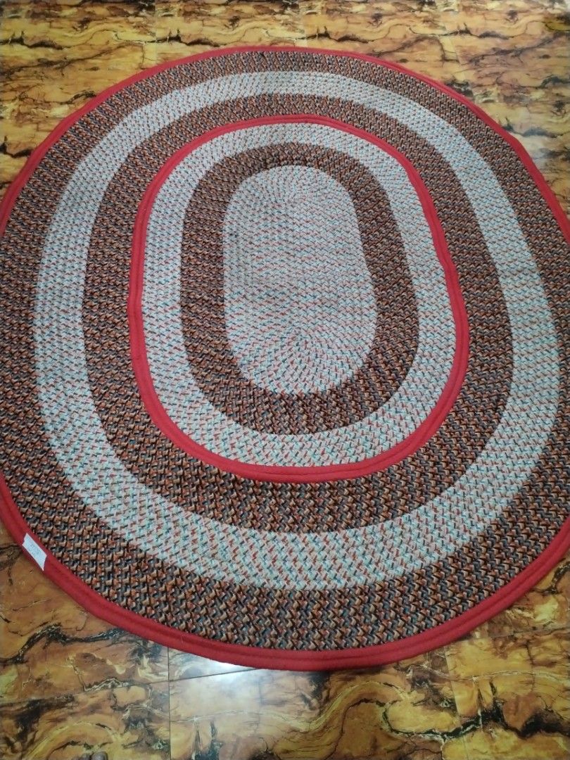 Braided Oval Rug Red Brown Multi 87x73 Inches (Category: Carpets, Mats & Flooring) located in Caloocan City. Submitted by rowely_jpn (Listing ID 1469100659, Image 1). Description: Japan surplus - Product: Oval braided rug with concentric rings - Size: 87 x 73 inches (based on handwritten label) - Color & Pattern: Red, brown, and multicoloured patterned weave - Material: Textured cotton/fabric construction - Durability: Heavy-duty floor covering -