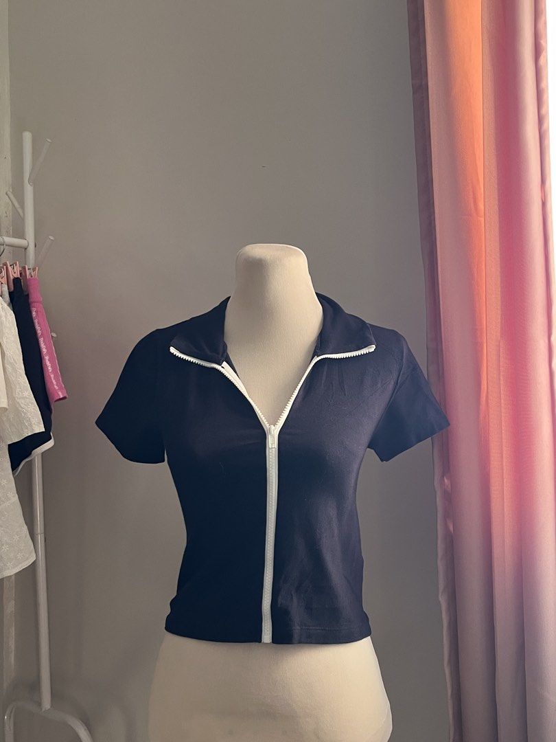 Brandy Melville Black Zip (Category: Shirts) located in Manila. Submitted by schiiiiiii (Listing ID 1468931674, Image 2). Description: - Brand: Brandy Melville - Color: Black with white front zipper - Style: Short sleeve crop top with high collar (can be zipped up or folded down) - Fit: Snug, soft, and stretchy fabric - Condition: Great pre-loved / like new - Perfect basic for layering or styling solo - Mode of Payment: GCash, BPI, or Maya - Ship