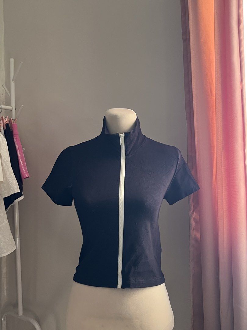 Brandy Melville Black Zip (Category: Shirts) located in Manila. Submitted by schiiiiiii (Listing ID 1468931674, Image 1). Description: - Brand: Brandy Melville - Color: Black with white front zipper - Style: Short sleeve crop top with high collar (can be zipped up or folded down) - Fit: Snug, soft, and stretchy fabric - Condition: Great pre-loved / like new - Perfect basic for layering or styling solo - Mode of Payment: GCash, BPI, or Maya - Ship