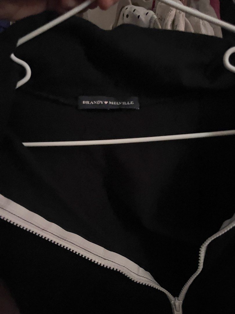 Brandy Melville Black Zip (Category: Shirts) located in Manila. Submitted by schiiiiiii (Listing ID 1468931674, Image 3). Description: - Brand: Brandy Melville - Color: Black with white front zipper - Style: Short sleeve crop top with high collar (can be zipped up or folded down) - Fit: Snug, soft, and stretchy fabric - Condition: Great pre-loved / like new - Perfect basic for layering or styling solo - Mode of Payment: GCash, BPI, or Maya - Ship