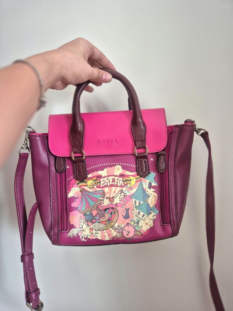 Brera Art Fever (Category: Cross-body Bags) located in Manila. Submitted by mommynurse (Listing ID 1468942672, Image 1). Description: two-way handbag or cross-body bag featuring a vibrant pink and purple color scheme with a whimsical carnival and carousel graphic print..