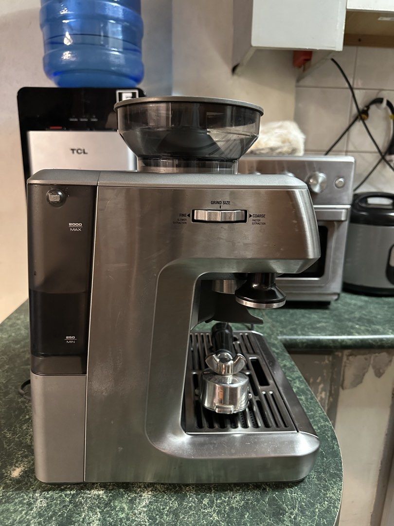Breville Barista Express Espresso Machine with Grinder (Category: Coffee Machines & Makers) located in Manila. Submitted by olxph_561736521 (Listing ID 1468949038, Image 2). Description: - Model: Breville espresso machine in brushed stainless steel finish - Grinder: Built-in conical burr grinder with side adjustable grind size dial - Controls: Centered pressure gauge with buttons for single/double shots, program settings, and manual control - Inc