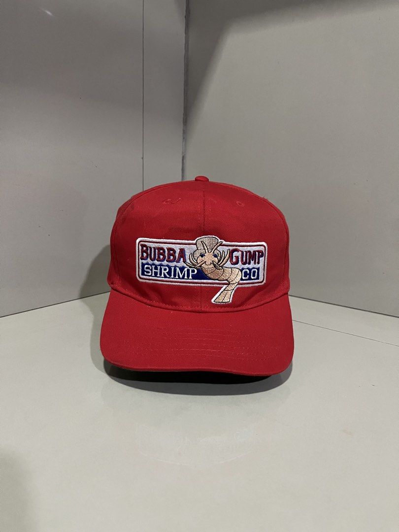 Bubba Gump Shrimp Co. Forrest Gump Snapback Cap (Category: Caps & Hats) located in Maasin. Submitted by niconii090 (Listing ID 1468984772, Image 1). Description: - Official Bubba Gump Shrimp Co. red snapback cap - Embroidered logo on the front and 'Forrest Gump' text in blue on the back - Classic green under-brim detail - Adjustable red plastic snap closure for a custom fit - 100% cotton material, made in China.