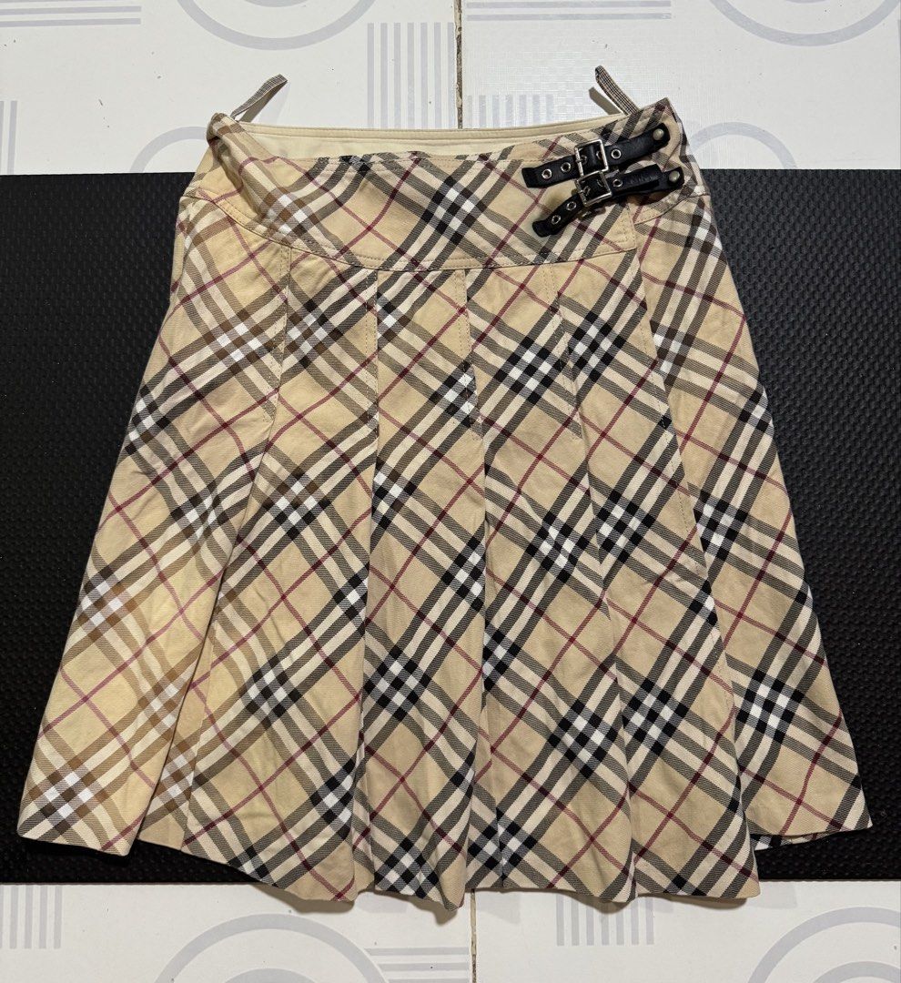 Burberry nova Plaid blue label (Category: Skirts) located in Cebu City. Submitted by etnaner (Listing ID 1468935624, Image 1). Description: Nova Plaid Size: 38 on tag fits 25-26W Issue some faded parts stain on leather buckle Still wearable .