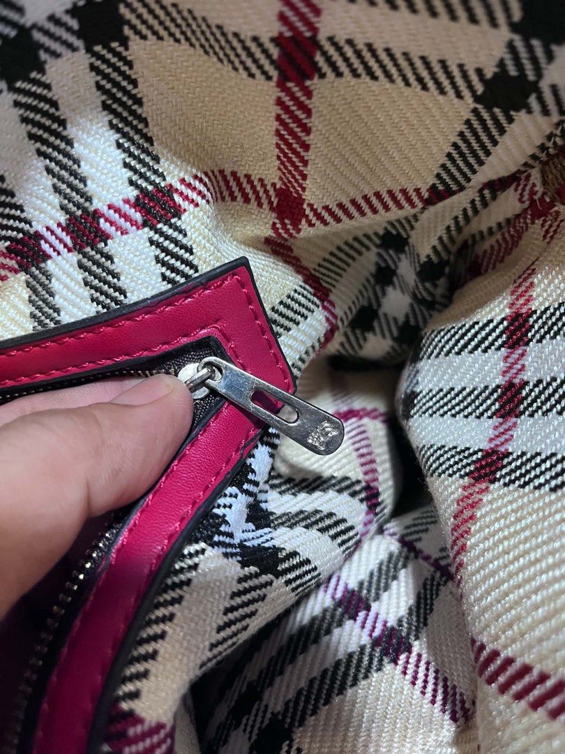 Burberry Plaid Handbag Pink (Category: Tote Bags) located in Dagupan City. Submitted by fahionista1988 (Listing ID 1469048722, Image 2). Description: - Brand: Burberry - Material: Pink plaid canvas with dark pink leather handles - Hardware: Gold-tone logo plaque and protective metal feet - Closure: Secure zip top - Interior: Plaid fabric lining, zip pocket, and embossed leather logo patch - Condition: Clean inside and out, well-maintained.