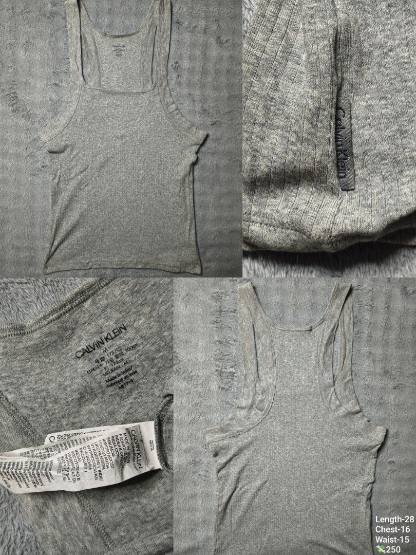 Calvin Klein Grey Ribbed Tank Top Size M (Category: Sleeveless) located in Floridablanca. Submitted by vintager12 (Listing ID 1469126031, Image 1). Description: - Brand: Calvin Klein - Color: Grey - Size: Medium (M) - Material: Stretchy ribbed cotton - Design: Scoop neck, racerback, and small woven logo label near hem - Measurements: Length 28", Chest 16", Waist 15" - Origin: Made in India with care labels attached.