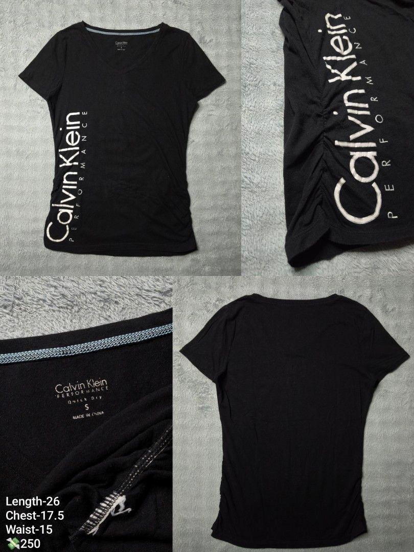 Calvin Klein Performance Quick Dry Black T-Shirt (Category: Luxury Apparel) located in Floridablanca. Submitted by vintager12 (Listing ID 1469125863, Image 1). Description: - Brand: Calvin Klein Performance - Color: Black with large white vertical logo - Size: S (Flat measurements: Length 26", Chest 17.5", Waist 15") - Material: Quick-dry performance fabric, ideal for workouts - Details: V-neck with blue contrast inner stitching and flattering ga