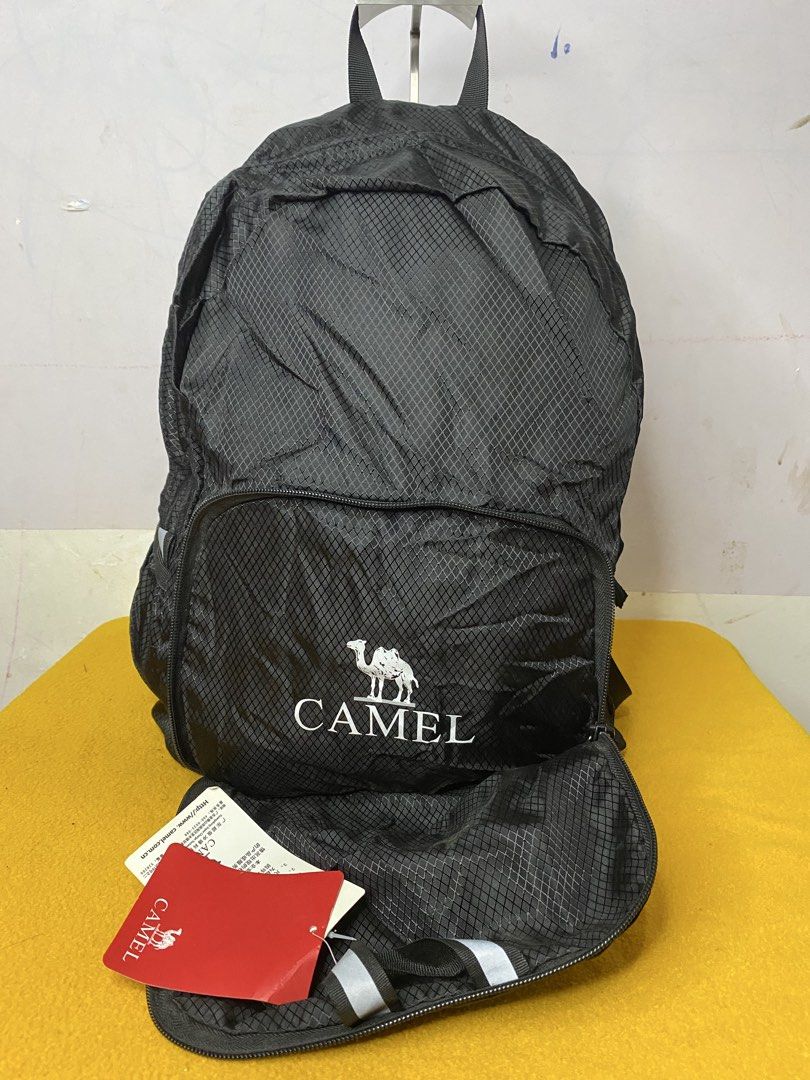 Camel Black Ripstop Backpack with Front Pocket (Category: Backpacks) located in Manila. Submitted by onfleekapparelph (Listing ID 1469068561, Image 2). Description: - Brand new with original red tags attached - Made from durable black ripstop material with a stylish small diamond grid pattern - Large main compartment for everyday essentials - Front zipped pocket featuring the signature white Camel logo and camel icon - Comfortable adjustable shou