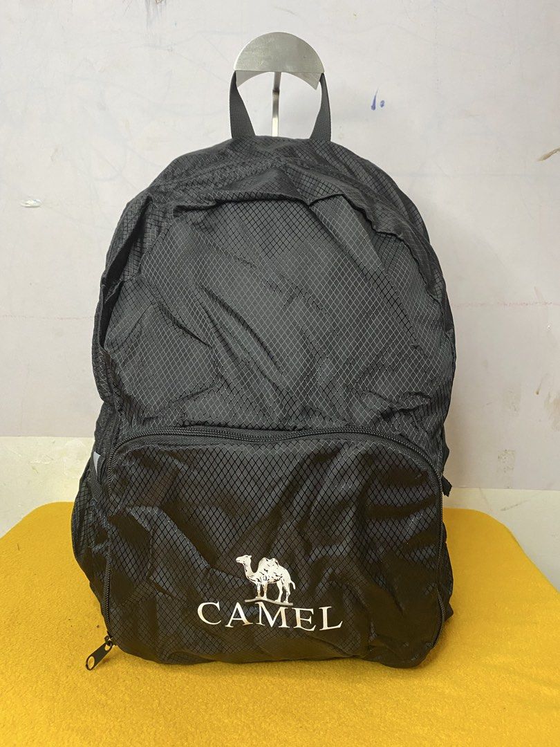 Camel Black Ripstop Backpack with Front Pocket (Category: Backpacks) located in Manila. Submitted by onfleekapparelph (Listing ID 1469068561, Image 1). Description: - Brand new with original red tags attached - Made from durable black ripstop material with a stylish small diamond grid pattern - Large main compartment for everyday essentials - Front zipped pocket featuring the signature white Camel logo and camel icon - Comfortable adjustable shou