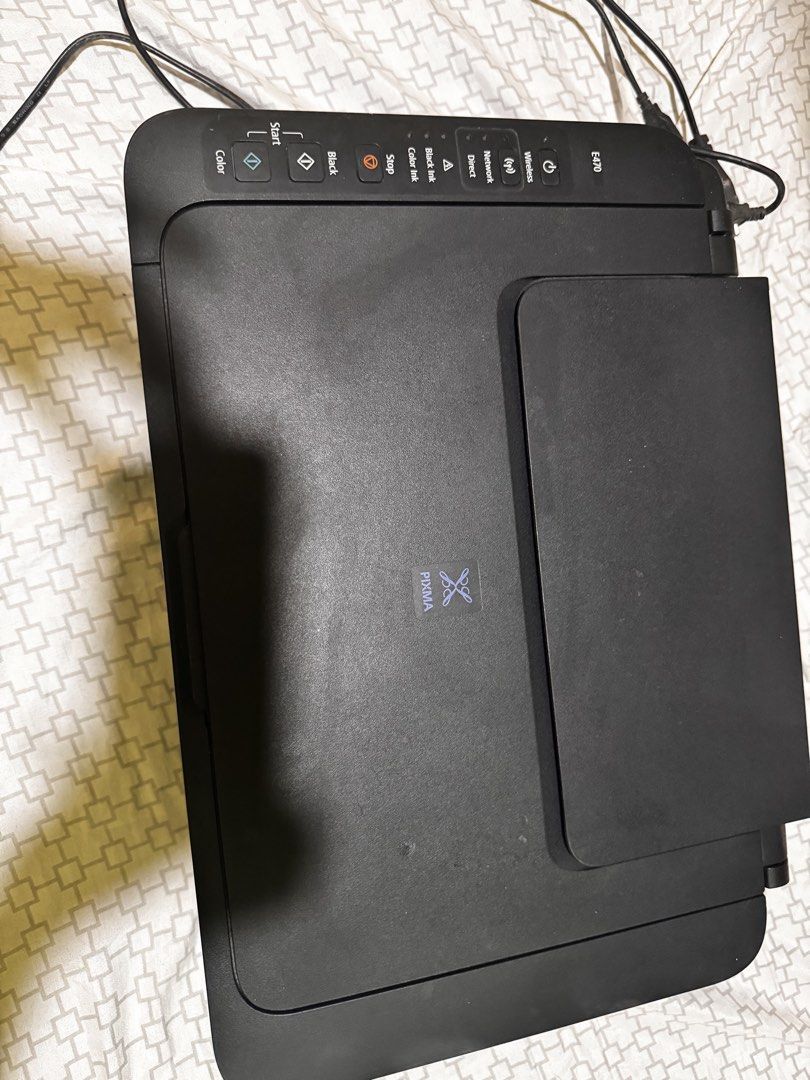Canon PIXMA E470 All-In-One Wireless Printer (Category: Printers, Scanners & Copiers) located in Manila. Submitted by ivoryscloset (Listing ID 1468953945, Image 1). Description: - Model: Canon PIXMA E470 Multifunction Printer (Black) - Features: Print, copy, and scan with the built-in flatbed scanner - Connectivity: Wireless setup capabilities for easy printing - Design: Compact footprint, perfect for small home office desks - Controls: User-frie