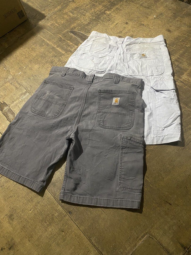 Carinhart Men Cargo Shorts Grey and White Bundle (Category: Shorts) located in Manila. Submitted by japhetcond32104 (Listing ID 1469111173, Image 1). Description: - Bundle includes: 2 pairs of Carhartt cargo shorts (Grey and Off-White) - Material: Heavy-duty, durable canvas - Features: Multiple utility pockets on both sides for maximum storage - Details: Standard button and zip fly, with woven Carhartt logo patch on the back pocket - Best for: Ca