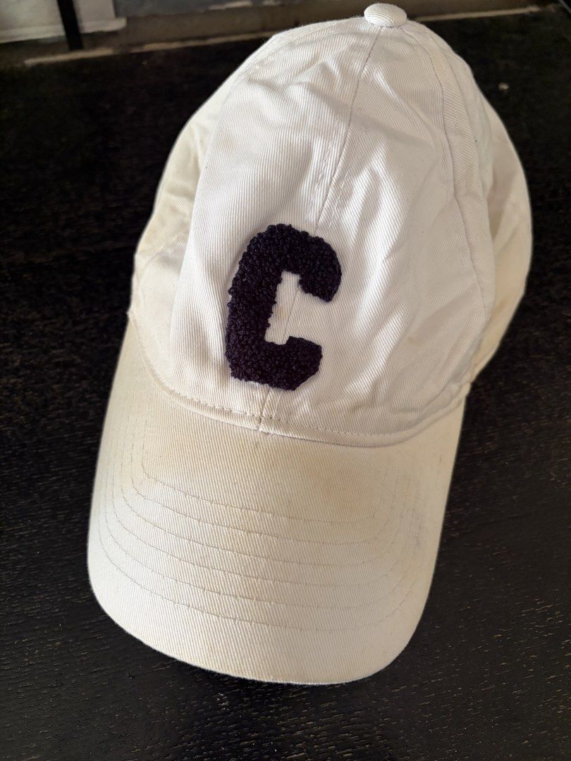 Celine White Baseball Cap with Black C Patch (Category: Caps & Hats) located in Manila. Submitted by trif21 (Listing ID 1468936254, Image 1). Description: - Brand: Celine - Color: White with black textured 'C' patch - Material: 65% polyester, 35% cotton - Origin: Made in France - Features: Adjustable metal strap stamped with Celine, branded interior tape, 'Do not wash' tag attached - Condition: need wash lang.