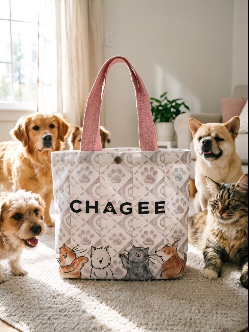 CHAGEE Pet Series Canvas Tote Bag (Cat & Dog Pattern) (Category: Homes & Other Pet Accessories) located in Pasig City. Submitted by swipeandpicks (Listing ID 1469085650, Image 3). Description: •Color: Pastel Pink base pattern with vibrant watercolor illustrations of cats and dogs, accented by soft blush pink woven cotton straps. •Material: Premium thick canvas / structured cotton blend with a secure snap-button closure on top. Features a water-re