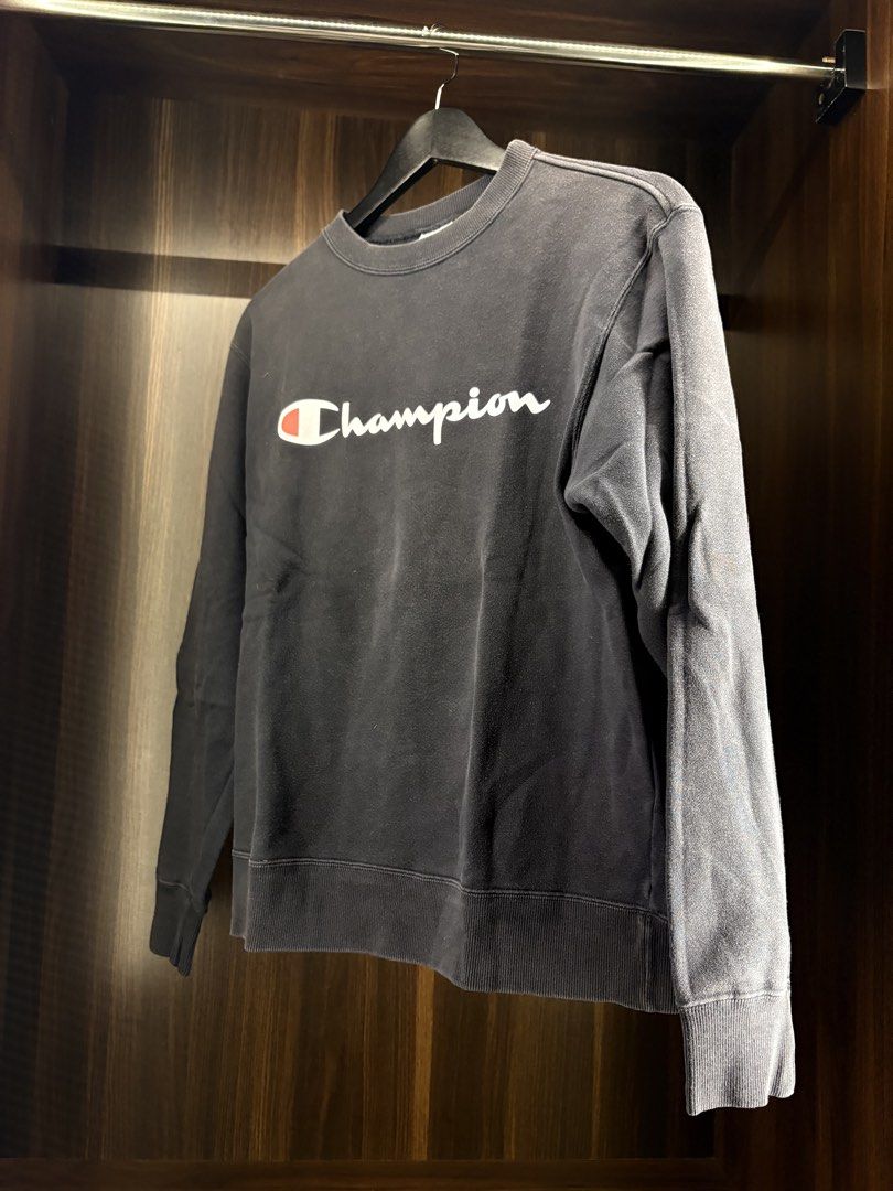 Champion Black Crewneck Sweatshirt with White Script Logo (Category: Coats, Jackets and Outerwear) located in Angeles City. Submitted by curt_morales (Listing ID 1469054411, Image 1). Description: - Color: Black with white script logo across the chest - Material: Soft and comfortable cotton blend - Fit: Classic pullover with long sleeves - Details: Ribbed cuffs and hem - Condition: Vibe of a faded wash from wear, perfect for casual everyday styli