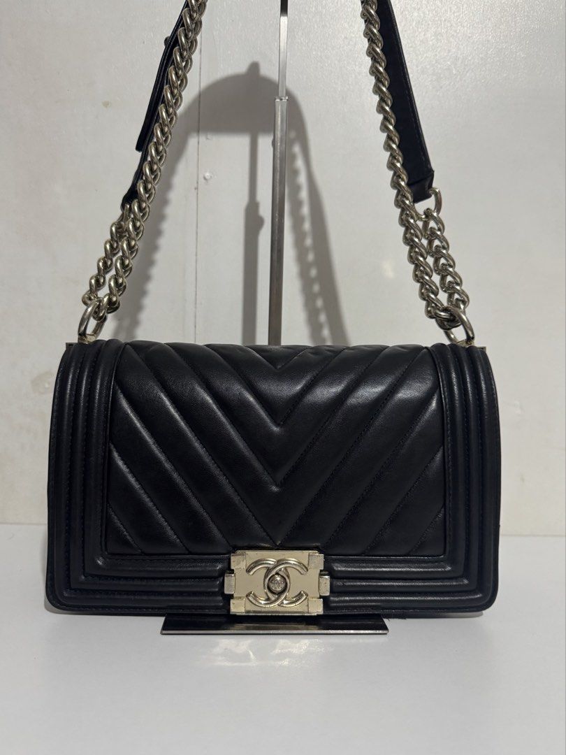 Chanel Chevron Boy Flap Bag Black (Category: Luxury Bags & Wallets) located in Manila. Submitted by reinjoseph (Listing ID 1469000811, Image 1). Description: - Brand: Chanel Boy Bag - Material: Black quilted chevron leather - Hardware: Silver tone with iconic CC push-lock closure - Strap: Chunky chain with leather shoulder pad and engraved metal links - Structure: Structured rectangular shape with reinforced borders - Style: Classic daily luxury 