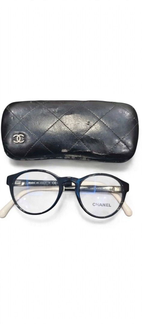 Chanel Eyeglasses Black Frame With Case (Category: Sunglasses & Eyewear) located in Manila. Submitted by mattmattmatt27 (Listing ID 1468944660, Image 1). Description: - Brand: Chanel - Style: Black and white round frame glasses - Lenses: Clear with Chanel branding on the right lens - Origin: Made in Italy - Inclusions: Original black quilted leatherette hard case with interlocking CC logo - Condition Note: Case has heavy wear and surface peeling 