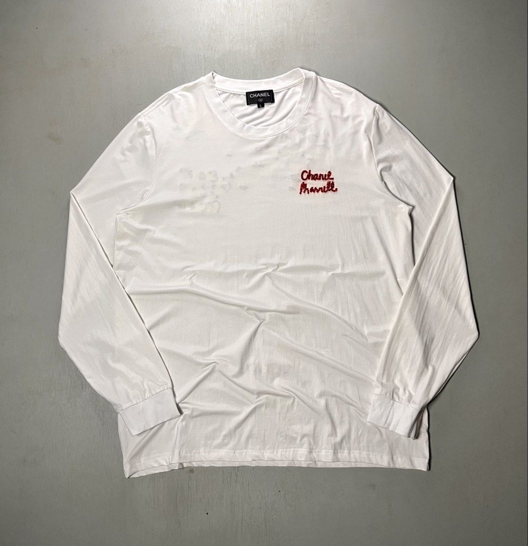 Chanel Pharrell Long Sleeve White (Category: Shirts) located in Catbalogan. Submitted by yellfindss (Listing ID 1469131517, Image 1). Description: - Brand: Chanel Pharrell - Color: White - Size: L -cotton: spandex - Design: Red embroidered 'Chanel Pharrell' on the front chest, statement graphic print and 'Wish List!' lettering on the back - Style: Long sleeve casual top / OOTD - Condition: Layered condition 4, well-maintained.