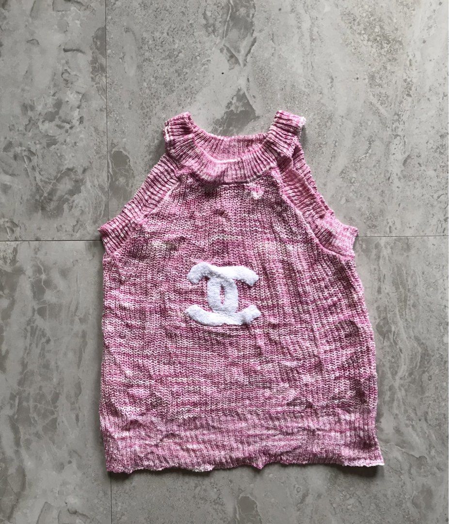 Chanel Pink Knit Tank Top (Category: Sleeveless) located in Banga. Submitted by jorguarino (Listing ID 1468937847, Image 1). Description: - Color: Pink with white Chanel logo in the center - Material: Super soft textured knit fabric - Design: Halter neckline with stylish ribbed trim - Versatility: Great for standalone wear or layering on warm days - PM for measurements or more details!.