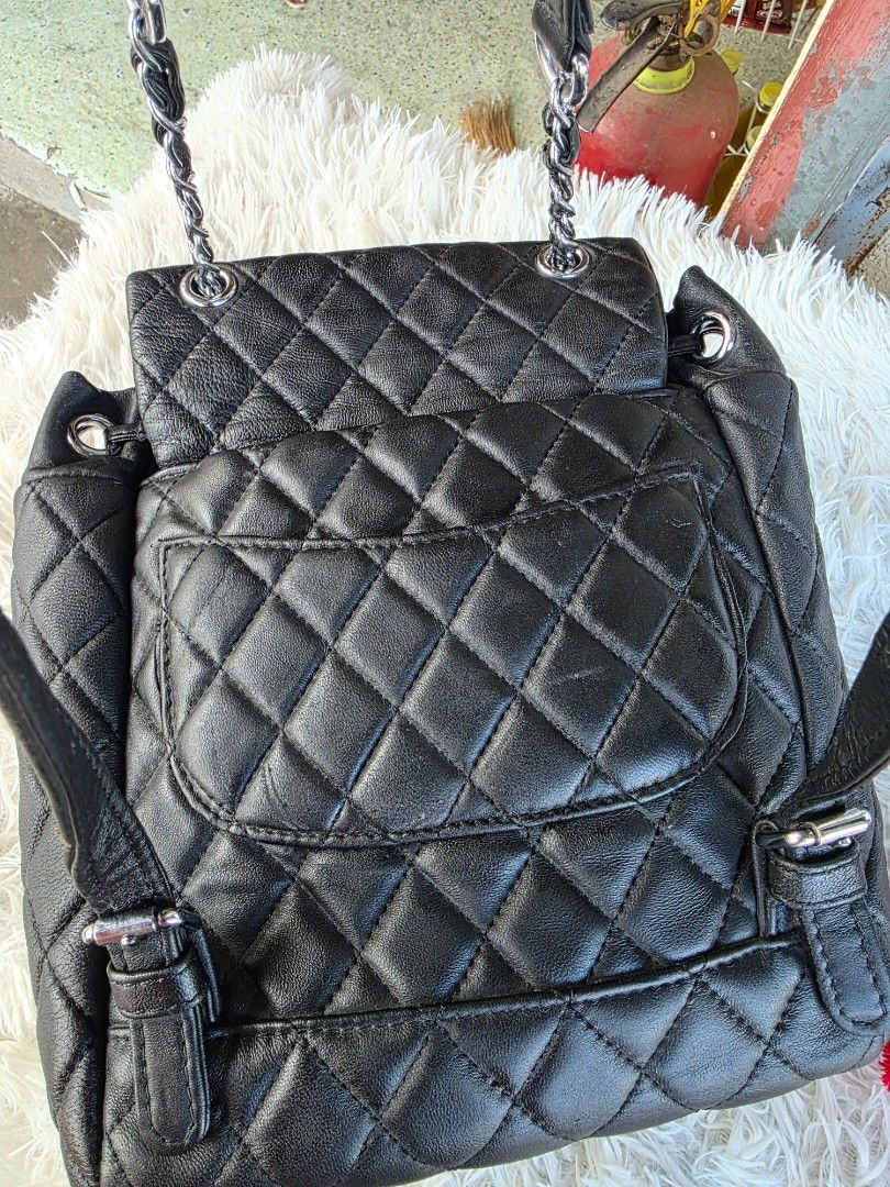 Chanel Quilted Black Leather Backpack Silver Hardware (Category: Backpacks) located in Lemery. Submitted by venus23 (Listing ID 1468930475, Image 3). Description: Black quilted leather backpack from Chanel. Silver-tone hardware and CC turn-lock closure on the front flap. Measures about ten inches across as shown in the tape measure photo. Adjustable leather and chain shoulder straps. Back pocket detail included. Clean interior and exterior, ready