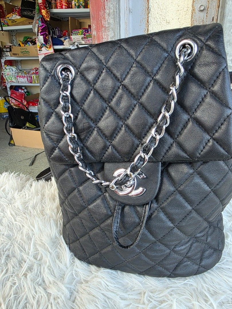Chanel Quilted Black Leather Backpack Silver Hardware (Category: Backpacks) located in Lemery. Submitted by venus23 (Listing ID 1468930475, Image 1). Description: Black quilted leather backpack from Chanel. Silver-tone hardware and CC turn-lock closure on the front flap. Measures about ten inches across as shown in the tape measure photo. Adjustable leather and chain shoulder straps. Back pocket detail included. Clean interior and exterior, ready