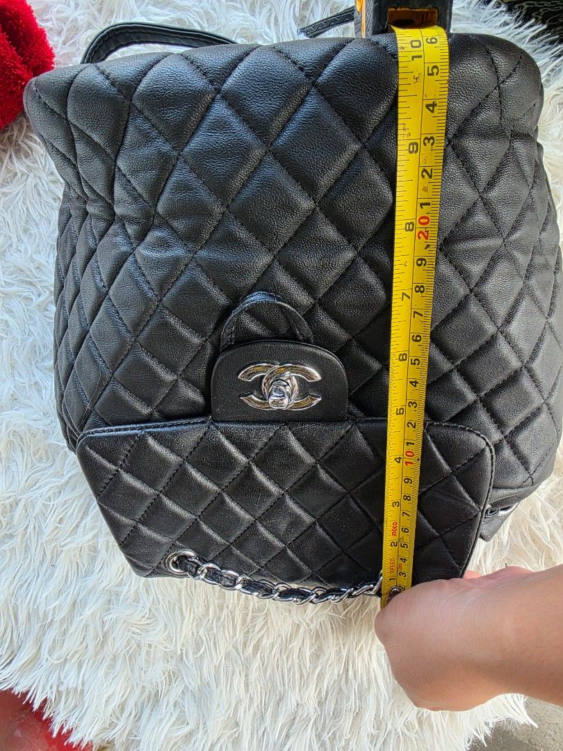 Chanel Quilted Black Leather Backpack Silver Hardware (Category: Backpacks) located in Lemery. Submitted by venus23 (Listing ID 1468930475, Image 2). Description: Black quilted leather backpack from Chanel. Silver-tone hardware and CC turn-lock closure on the front flap. Measures about ten inches across as shown in the tape measure photo. Adjustable leather and chain shoulder straps. Back pocket detail included. Clean interior and exterior, ready