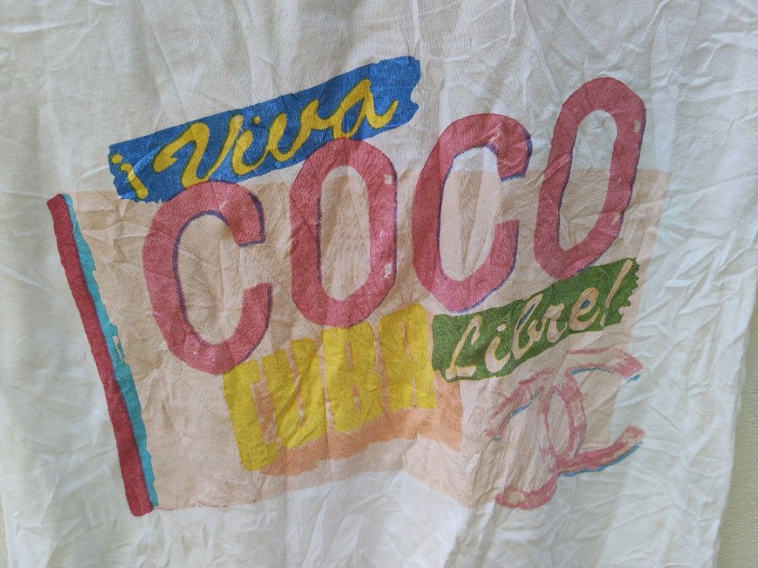 Chanel Viva Coco Libre Graphic Raglan T-Shirt (Category: Shirts) located in City of Isabela. Submitted by jasheverything (Listing ID 1468946546, Image 3). Description: - Brand: Chanel Vintage - Color: White and light pink with contrasting blue trim - Design: 'Viva COCO Libre!' large graphic print on front - Material: 100% cotton, Made in France - Size: 36 (Regular fit, short sleeves) - Condition: Excellent collector's item with unique typography 