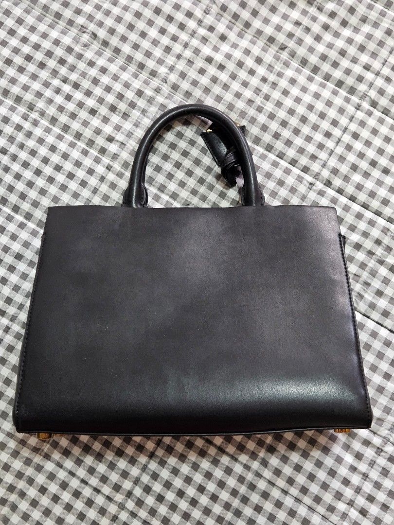 Charles & Keith Black Structured Handbag (Category: Luxury Bags & Wallets) located in San Juan City. Submitted by jammanbo (Listing ID 1468967992, Image 2). Description: well used but not abused pls manage your expectation strap not included dust bag included see photos for details shipping shouldered by buyer loc. san juan city.