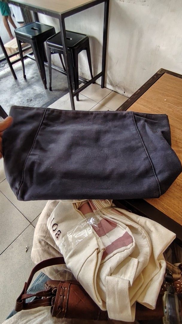 Charles & Keith Canvas big size pouch (Category: Tote Bags) located in Manila. Submitted by purediamond888 (Listing ID 1469037398, Image 1). Description: - Brand: Charles & Keith - Color: Dark grey canvas exterior with blue lining and bright orange interior pockets - Compartments: Spacious main compartment with multiple interior pockets, including one zippered pocket - Closure: Secure top zipper - Condition: Minor wear on the interior and brand t